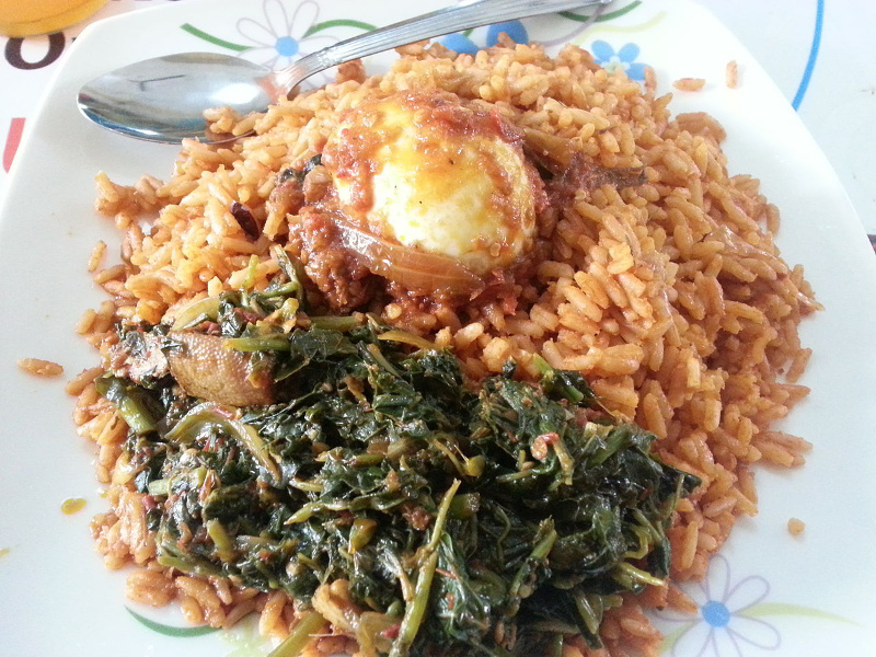 Jollof rice with greens and a hard-boiled egg