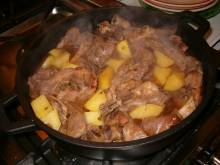Pot of simmering lamb and potato bredie